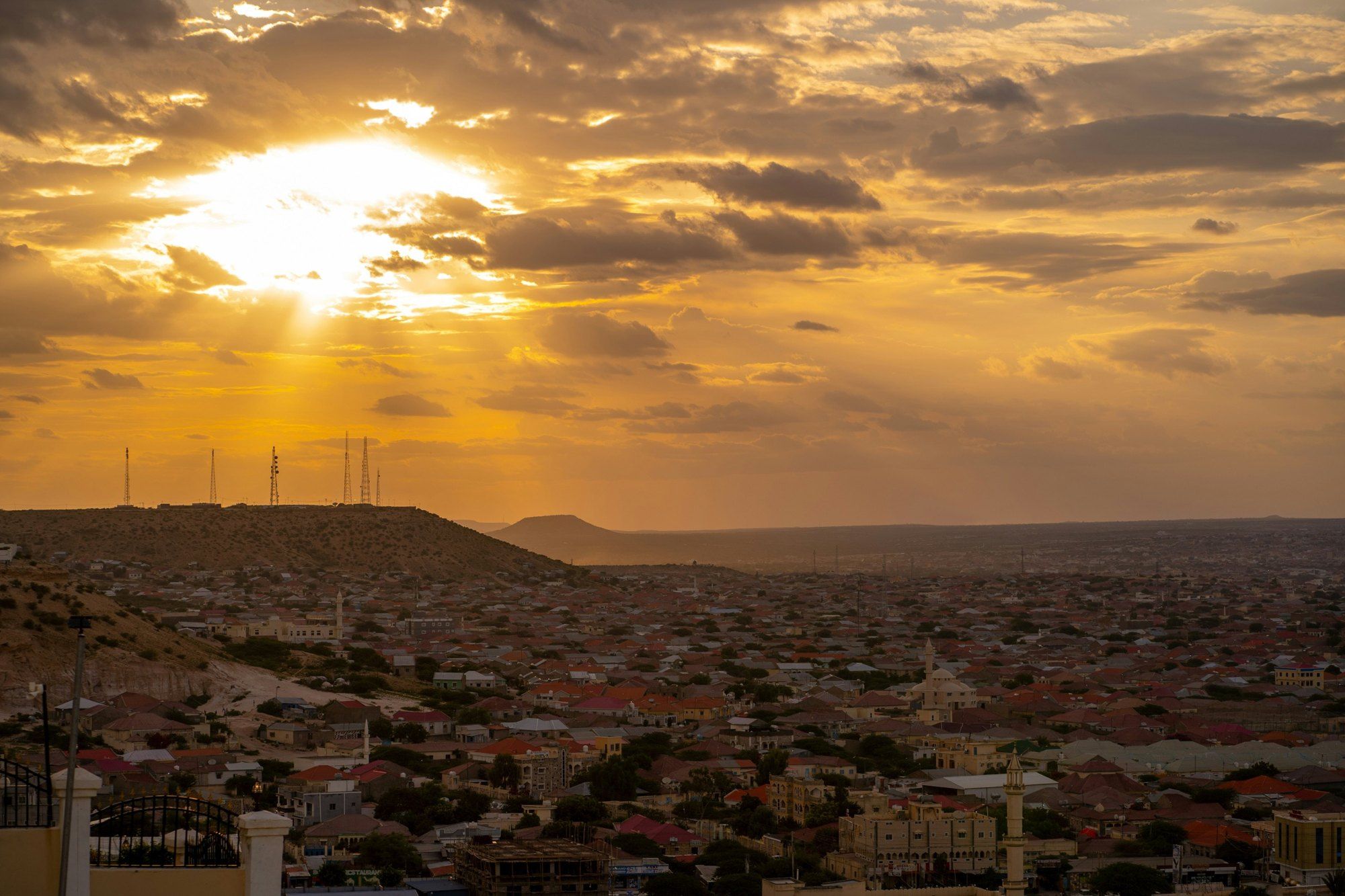 Sun breaking through cloud over Hargeisa's rooftops and hills.