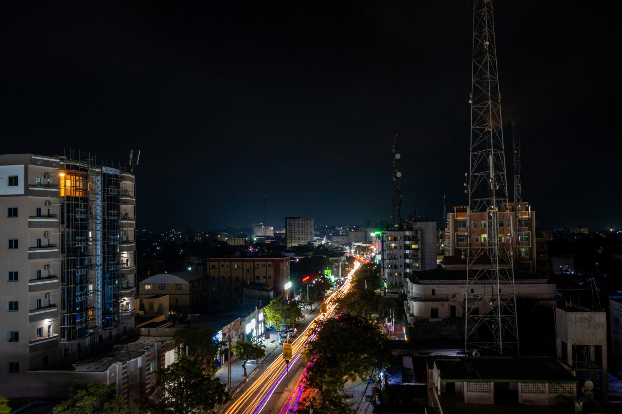 Mogadishu at night from a rooftop, with light trails along a boulevard.